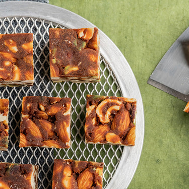 https://cdn.shopify.com/s/files/1/1857/6931/files/VellankiFoodsSugarFreeDryFruitBurfi.jpg?v=1716899159